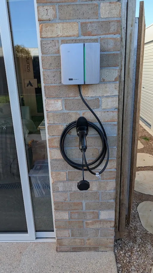Wall-mounted home EV charger installed on an outdoor brick pillar, Geelong