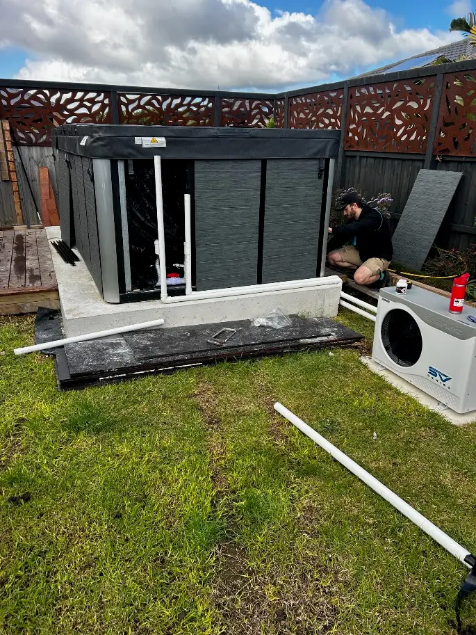 Swim spa wiring in progress with heat pump connection on a concrete slab, Geelong